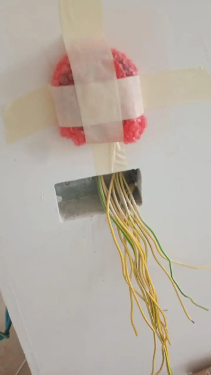 Technician modifying DC Fan Coil wiring in JVC