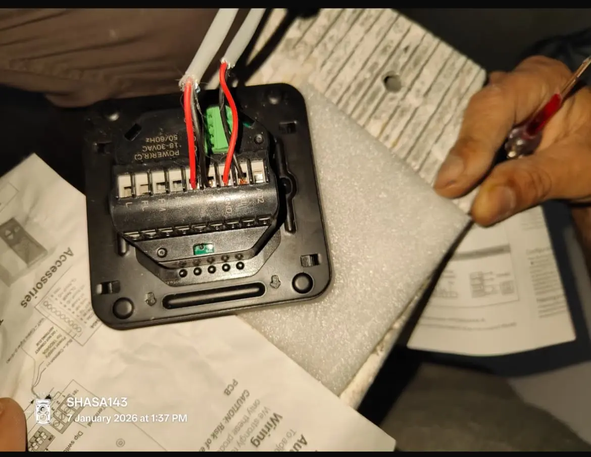 DHRS technician wiring a 24-Volt AC conversion box for a smart thermostat upgrade in Dubai